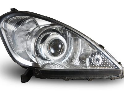 Modern car projector headlight isolated on white