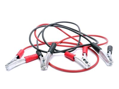 Two twisted jumper cables shot over white